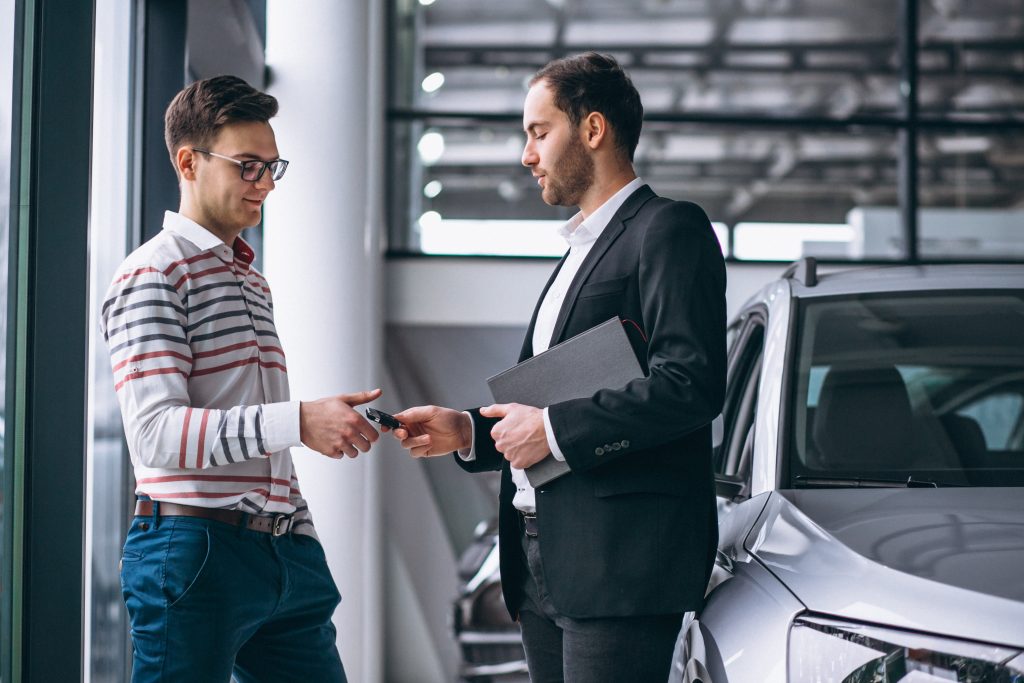 Customer Receiving Car Keys at Dubai Car Rental Office